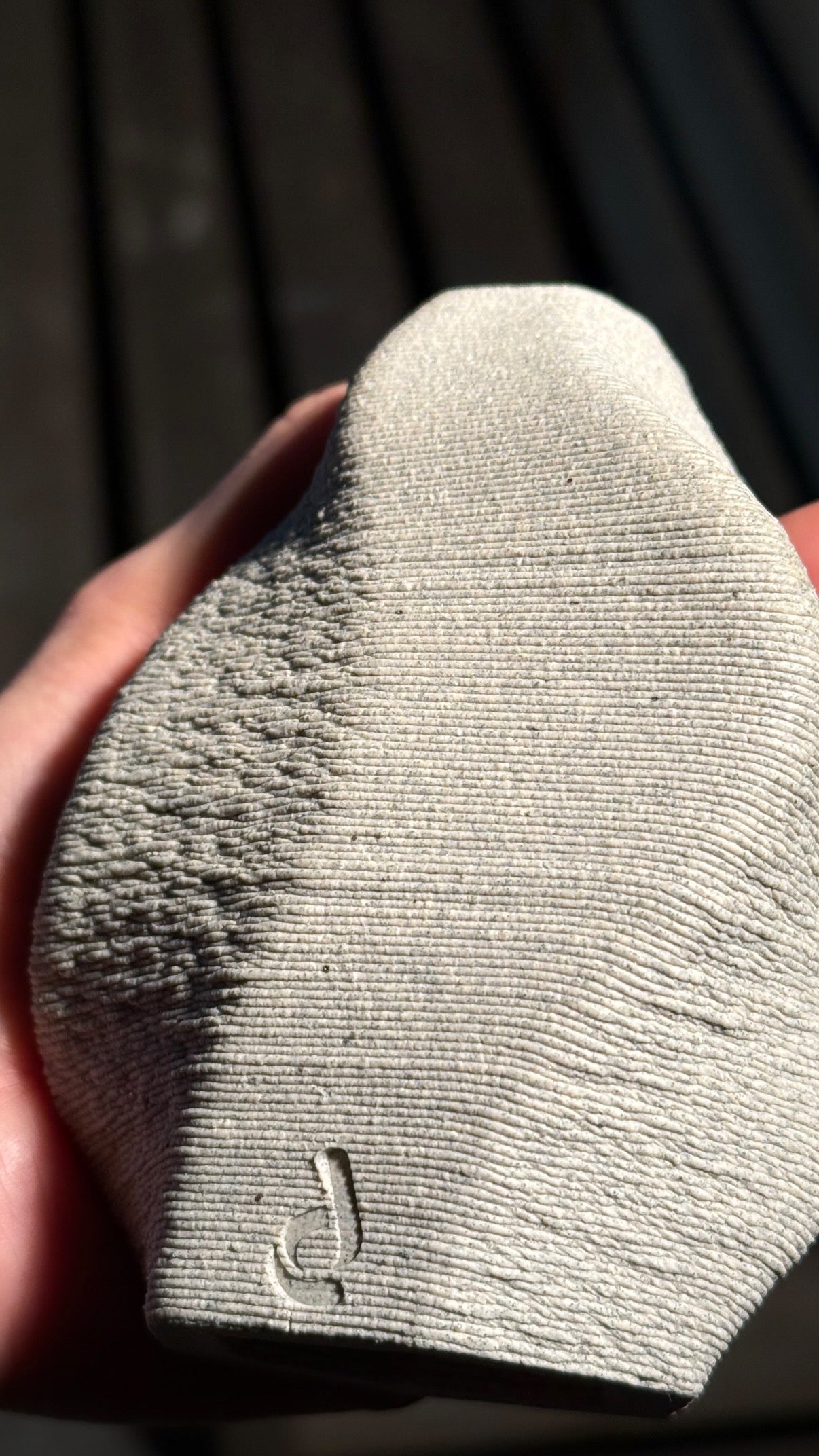 A Deramic ceramic piece, held in studio